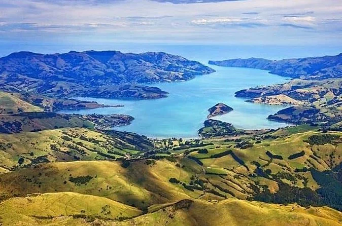 Akaroa Harbour seen from the crater rim, green hills and blue inlets